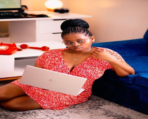 man working on a laptop at home in Kenya